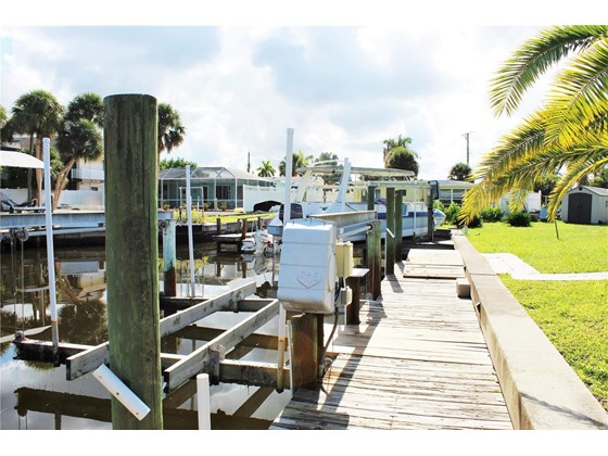 Dock with boat lift and electric. - Single Family Home for sale at 1345 Holiday Dr, Englewood, FL 34223 - MLS Number is C7449205