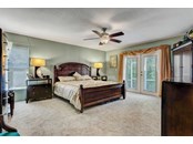 Master bedroom with French doors to pool area - Single Family Home for sale at 1518 Bel Air Star Pkwy, Sarasota, FL 34240 - MLS Number is A4506654