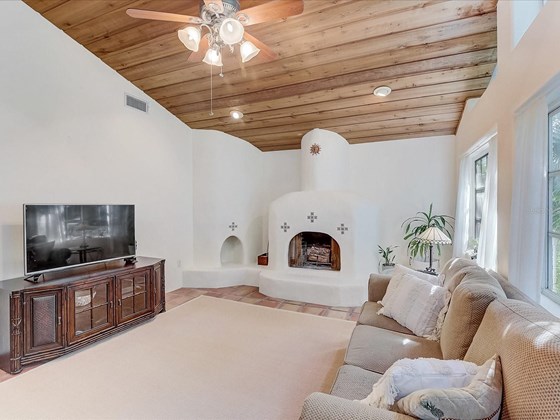 Expansive great room with adobe style fireplace - Single Family Home for sale at 5227 Siesta Cove Dr, Sarasota, FL 34242 - MLS Number is A4519271