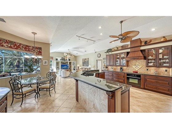 Just past the formal areas, you enter into the open concept eat-in kitchen and family room. - Single Family Home for sale at 8821 Misty Creek Dr, Sarasota, FL 34241 - MLS Number is A4521942