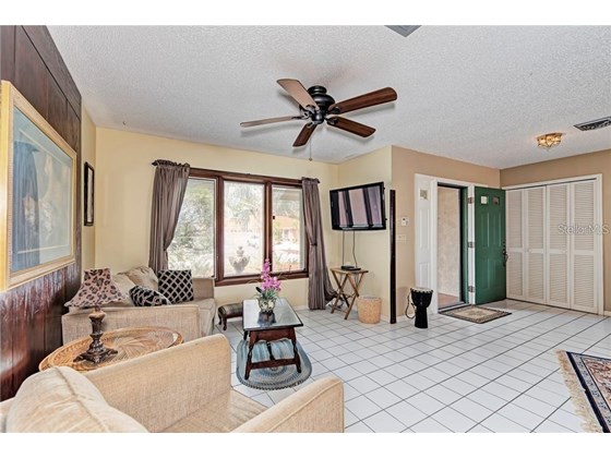 large front room being used as large dining area, could be formal living room with pocket sliders to lanai - Single Family Home for sale at 10 Pine Ridge Way, Englewood, FL 34223 - MLS Number is N6118641